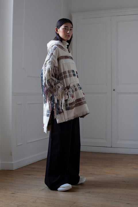 The artisanal fringe hoody is a mix of tweed fabrics from luxury houses deadstock. This unique piece is made locally in Paris to reduce environmental impact and guarantee high quality and durability of the products. It is gender neutral, has oversize fit and has a minimal impact on environment.