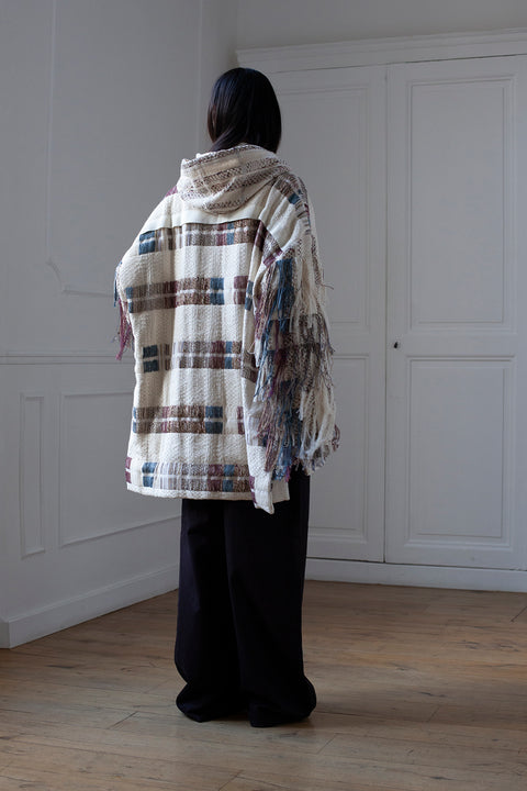 The artisanal fringe hoody is a mix of tweed fabrics from luxury houses deadstock. This unique piece is made locally in Paris to reduce environmental impact and guarantee high quality and durability of the products. It is gender neutral, has oversize fit and has a minimal impact on environment.