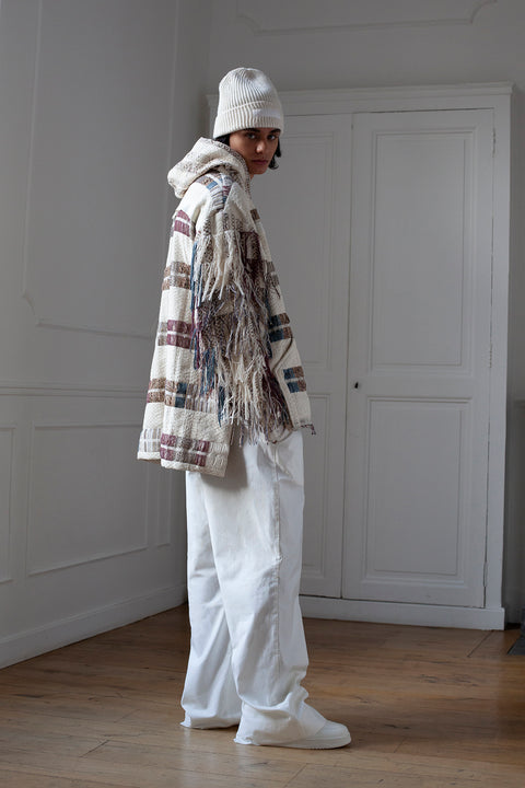 The artisanal fringe hoody is a mix of tweed fabrics from luxury houses deadstock. This unique piece is made locally in Paris to reduce environmental impact and guarantee high quality and durability of the products. It is gender neutral, has oversize fit and has a minimal impact on environment.