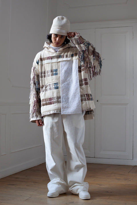 The artisanal fringe hoody is a mix of tweed fabrics from luxury houses deadstock. This unique piece is made locally in Paris to reduce environmental impact and guarantee high quality and durability of the products. It is gender neutral, has oversize fit and has a minimal impact on environment.