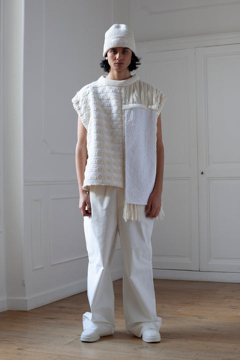 The artisanal sleeveless sweater is a mix of tweed fabrics from luxury houses deadstock. This unique piece is made locally in Paris to reduce environmental impact and guarantee high quality and durability of the products. It is gender neutral, has oversize fit and has a minimal impact on environment.