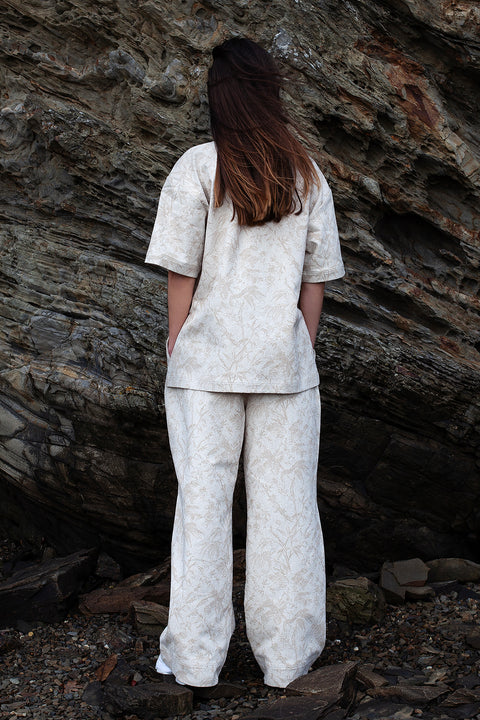Romane is wearing White Canvas jacquard natural color, oversized, genderless, seasonless casual t-shirt, one size. The Essential jacquard t-shirt has minimal modern aesthetics design allowing comfort and bringing self-confidence. This unique piece is made locally in Paris to reduce environmental impact and guarantee high quality and durability of the products.