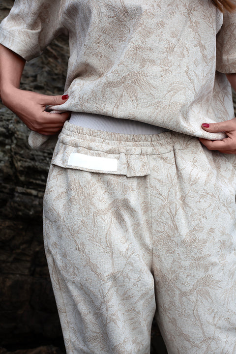 Romane is wearing White Canvas jacquard natural color, oversized, genderless, seasonless casual t-shirt, one size. The Essential jacquard t-shirt has minimal modern aesthetics design allowing comfort and bringing self-confidence. This unique piece is made locally in Paris to reduce environmental impact and guarantee high quality and durability of the products.