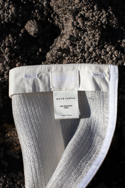 The silver fringes panel is an exclusive unique sustainable piece made in France. It is made to be attached to the essential pieces to personalize them and wear them your unique way.