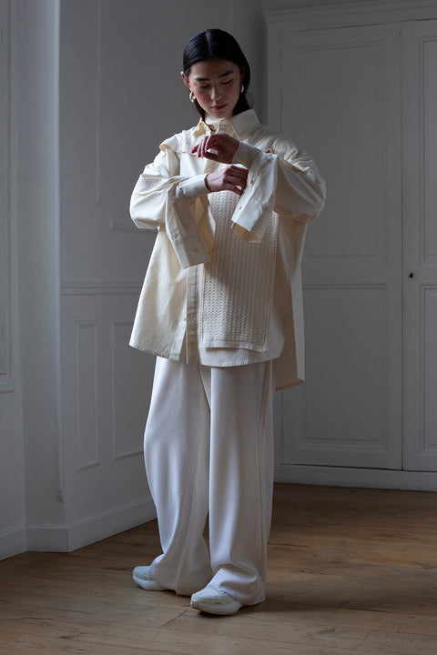 SiJia is wearing the White Canvas essentails wool trousers and organic cotton oversized gender neutral shirt styled with the checks tweed vertical fabric panel made from leftover deadstock fabrics. The tweed panel is an exclusive unique sustainable piece made in France. It is made to be attached to the essential pieces to personalize them and wear them your unique way.