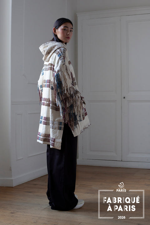 The artisanal fringe hoody is a mix of tweed fabrics from luxury houses deadstock. This unique piece is made locally in Paris to reduce environmental impact and guarantee high quality and durability of the products. It is gender neutral, has oversize fit and has a minimal impact on environment.