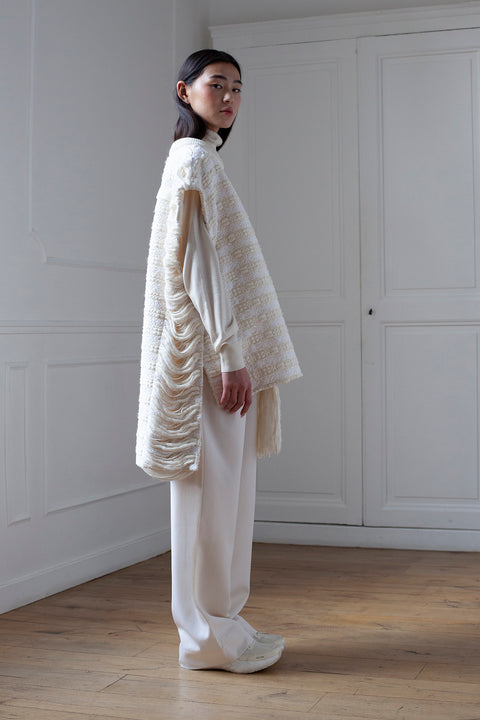 The artisanal sleeveless sweater is a mix of tweed fabrics from luxury houses deadstock. This unique piece is made locally in Paris to reduce environmental impact and guarantee high quality and durability of the products. It is gender neutral, has oversize fit and has a minimal impact on environment.