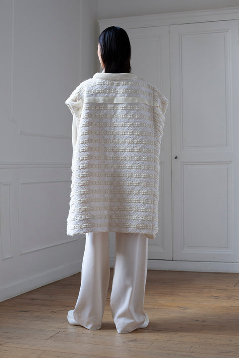 The artisanal sleeveless sweater is a mix of tweed fabrics from luxury houses deadstock. This unique piece is made locally in Paris to reduce environmental impact and guarantee high quality and durability of the products. It is gender neutral, has oversize fit and has a minimal impact on environment.