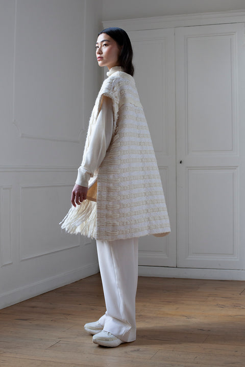 The artisanal sleeveless sweater is a mix of tweed fabrics from luxury houses deadstock. This unique piece is made locally in Paris to reduce environmental impact and guarantee high quality and durability of the products. It is gender neutral, has oversize fit and has a minimal impact on environment.