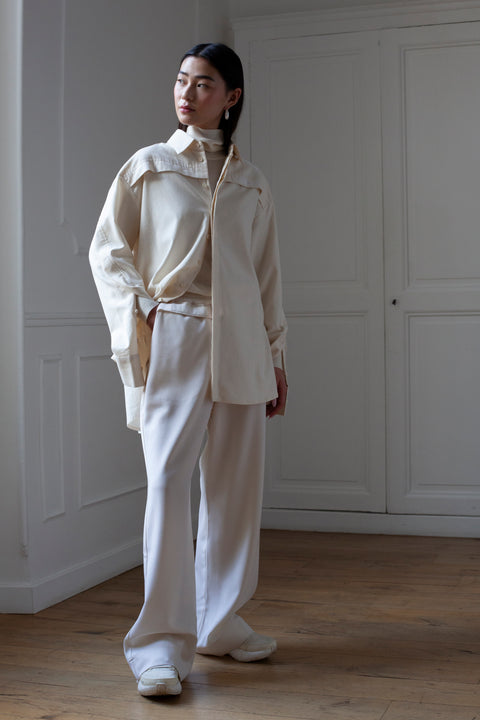 SiJia is wearing the White Canvas essentails loose fit wool trousers and organic cotton oversized gender neutral shirt.