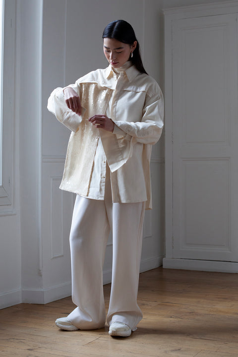 SiJia is wearing the White Canvas essentails wool trousers and organic cotton oversized gender neutral shirt styled with the sequins vertical fabric panel made from leftover deadstock fabrics. The sequins panel is an exclusive unique sustainable piece made in France. It is made to be attached to the essential pieces to personalize them and wear them your unique way.