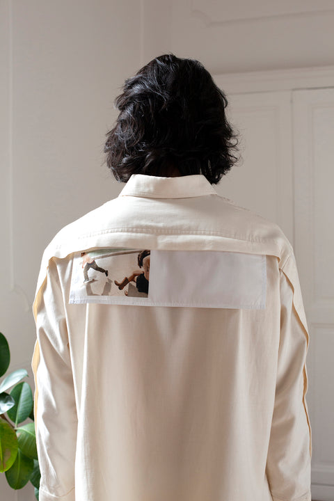 Medhi is wearing the White Canvas ESSENTIAL SHIRT styled with the Skater horizontal panel made from deadstock white cotton poplin. The panel has an exclusive print of a photo by the photographer Henrique Soares. Attach the panel to the essential pieces to personalize them and wear them your unique way. It is the perfect creative summer accessory.