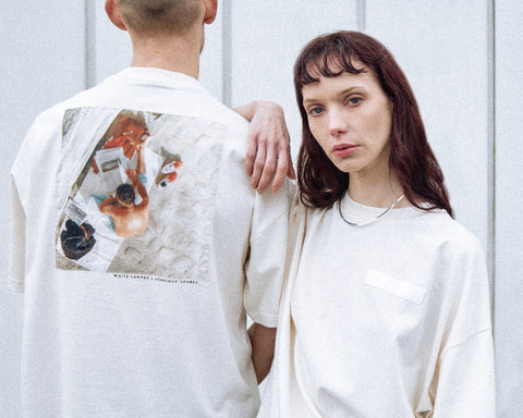 Two models are wearing the White Canvas Originals sustainable, oversized, genderless t-shirt, one size. The organic cotton natural color t-shirt has minimal modern aesthetics design allowing comfort and bringing self-confidence. This limited edition collection is made in Portugal to reduce environmental impact and guarantee high quality and durability of the products. There is a photo by the photographer Henrique Soares at the back of the t-shirt.