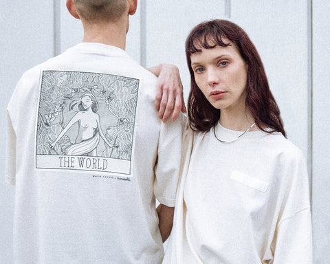 The two models are wearing the White Canvas Originals sustainable, oversized, genderless t-shirt, one size. The organic cotton natural color t-shirt has minimal modern aesthetics design allowing comfort and bringing self-confidence. This limited edition collection is made in Portugal to reduce environmental impact and guarantee high quality and durability of the products.