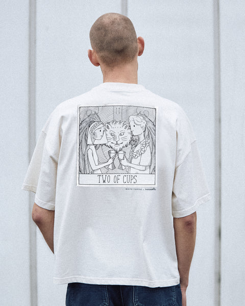 A male model is wearing the White Canvas Originals sustainable, oversized, genderless t-shirt, one size. The organic cotton, natural color t-shirt has minimal modern aesthetics design allowing comfort and bringing self-confidence. This limited edition collection is made in Portugal to reduce environmental impact and guarantee high quality and durability of the products.