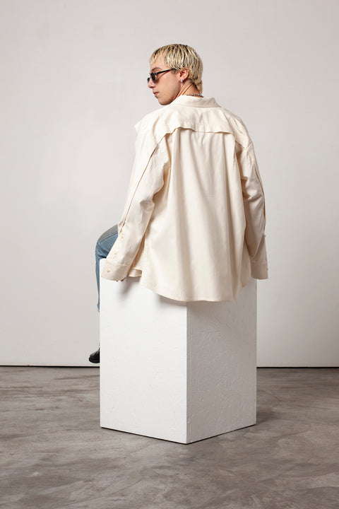Clément is wearing White Canvas sustainable natural beige color, organic cotton oversized, genderless, inclusive, seasonless casual shirt, size L/XL. The Essential shirt has minimal modern aesthetics design allowing comfort and bringing self-confidence. A limited-edition production is made locally in France to reduce environmental impact and guarantee high quality and durability of the products.