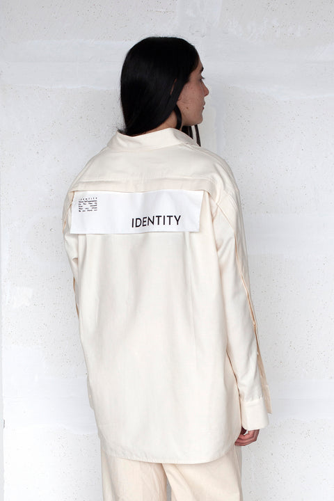 The White Canvas ESSENTIAL SHIRT with white cotton poplin fabric panel made from leftover deadstock fabrics and with black artisanal eco-friendly screen print done locally in Paris in collaboration with RoStudio. Attach the panel to the essential pieces to personalize them and wear them your unique way