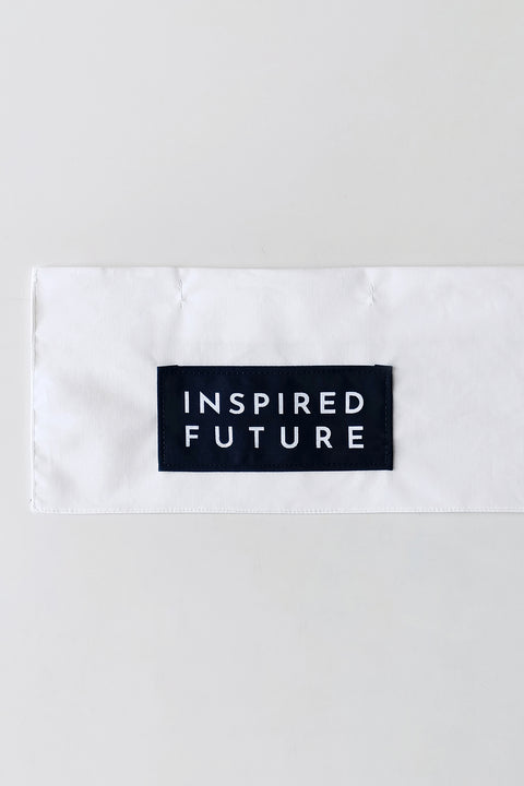 Detail. The White Canvas white cotton poplin fabric panel made from leftover deadstock fabrics and with black patch and artisanal eco-friendly screen print done locally in Paris in collaboration with RoStudio. Attach the panel to the essential pieces to personalize them and wear them your unique way