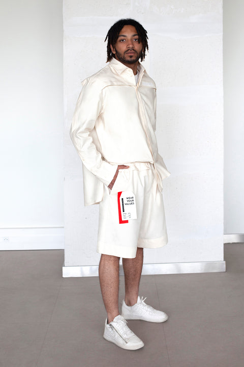 The White Canvas ESSENTIAL SHIRT and SHORT with a limited edition tag made in white and red cotton poplin leftover deadstock fabrics and with black artisanal eco-friendly screen print done locally in Paris in collaboration with RoStudio. Attach the panel to the essential pieces to personalize them and wear them your unique way. The tag is sold with key holder in recycled plastic made in collaboration with Samji Atelier