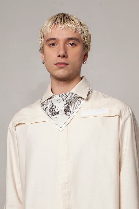 Clément is wearing the White Canvas ESSENTIAL SHIRT styled with THE WORLD triangular panel & bandana made from leftover deadstock white cotton poplin. The bandana has an exclusive design inspired by tarot cards drawn by the artist Maria Robla and printed with black artisanal eco-friendly ink locally in Paris in collaboration with RoStudio. Wear the black and white bandana alone or attach it to the essential pieces to personalize them and wear them your unique way. Your perfect summer accessory.