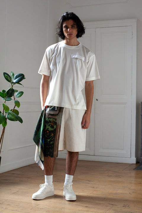 Medhi is wearing White Canvas sustainable denim genderless casual shorts, size M. The denim shorts have minimal modern aesthetics design allowing comfort and bringing self-confidence. This unique piece is made locally in Paris to reduce environmental impact and guarantee high quality and durability of the products.