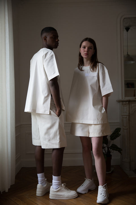 Thierno and Dalva are wearing White Canvas sustainable white, oversized, genderless, seasonless t-shirt, one size. The cotton stripes t-shirt has minimal modern aesthetics design allowing comfort and bringing self-confidence. This unique piece is made locally in Paris to reduce environmental impact and guarantee high quality and durability of the products. 