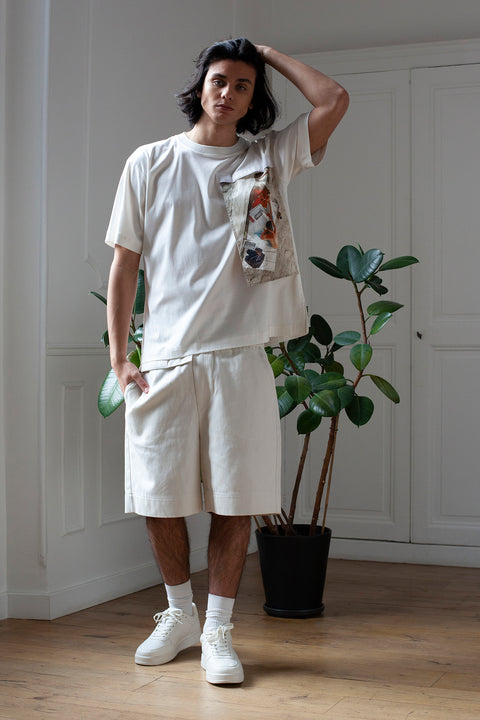 Medhi is wearing White Canvas sustainable off white cotton jersey oversized, genderless, seasonless t-shirt, one size. The off white cotton jersey t-shirt has minimal modern aesthetics design allowing comfort and bringing self-confidence. This unique piece is made locally in Paris to reduce environmental impact and guarantee high quality and durability of the products. 
