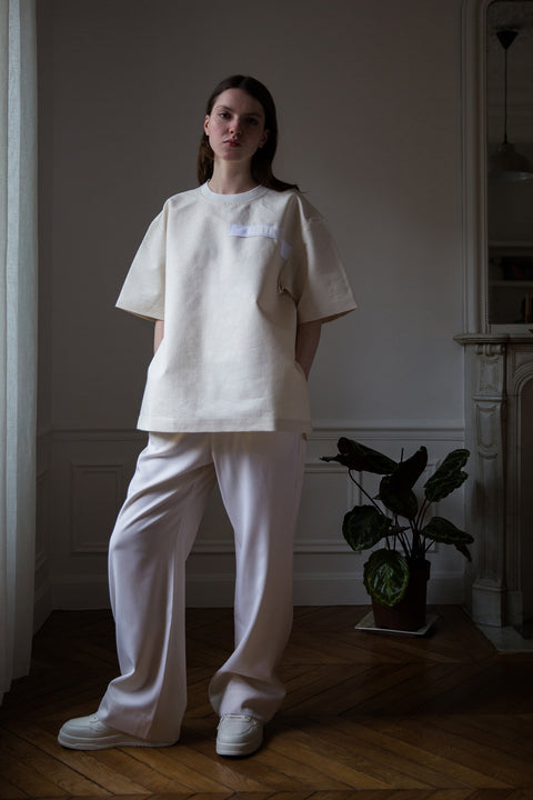 Dalva is wearing White Canvas sustainable floral jacquard oversized, genderless, seasonless t-shirt, one size. The floral jacquard t-shirt has minimal modern aesthetics design allowing comfort and bringing self-confidence. This unique piece is made locally in Paris to reduce environmental impact and guarantee high quality and durability of the products. 