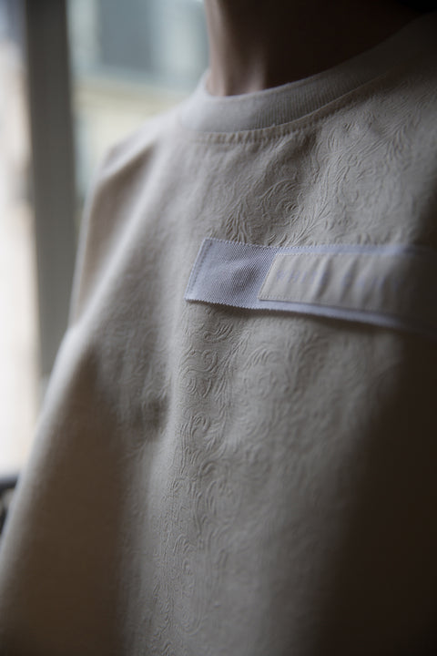 Dalva is wearing White Canvas sustainable floral jacquard oversized, genderless, seasonless t-shirt, one size. The floral jacquard t-shirt has minimal modern aesthetics design allowing comfort and bringing self-confidence. This unique piece is made locally in Paris to reduce environmental impact and guarantee high quality and durability of the products. 