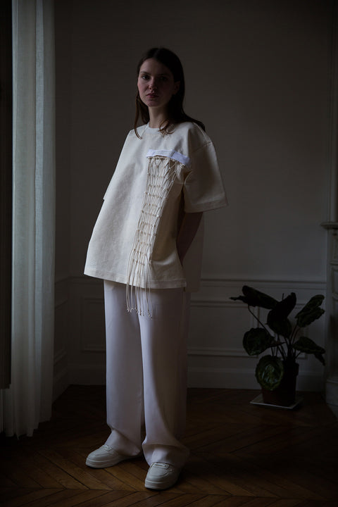 Dalva is wearing White Canvas sustainable floral jacquard oversized, genderless, seasonless t-shirt, one size. The floral jacquard t-shirt has minimal modern aesthetics design allowing comfort and bringing self-confidence. This unique piece is made locally in Paris to reduce environmental impact and guarantee high quality and durability of the products. 