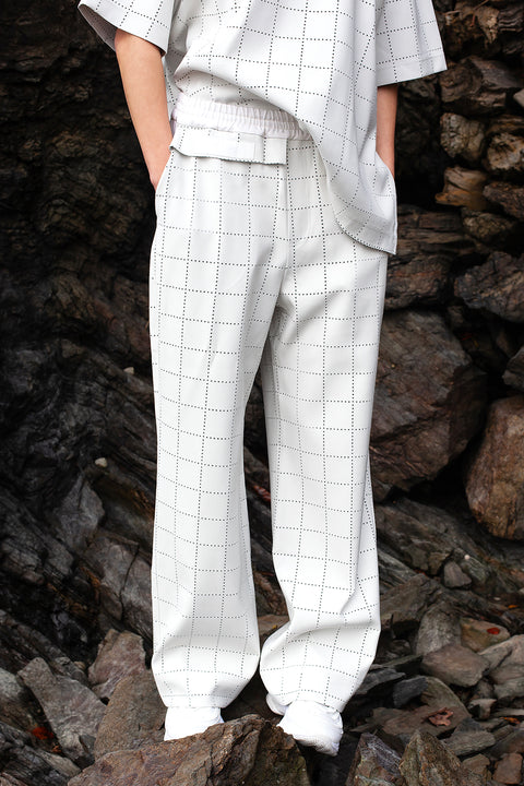 Romane is wearing White Canvas sustainable light grey color, genderless, seasonless casual checks trousers, size S. The Essential checks trousers have minimal modern aesthetics design allowing comfort and bringing self-confidence. This unique piece is made locally in Paris to reduce environmental impact and guarantee high quality and durability of the products. 