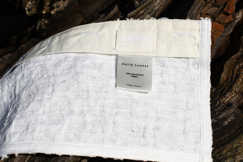 The white tweed horizontal panel is an exclusive unique sustainable piece made in France. It is made to be attached to the essential pieces to personalize them and wear them your unique way.