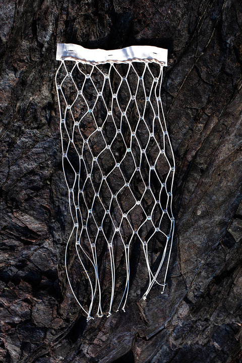 The net vertical panel with recycled beads is an exclusive unique sustainable piece made in France. It is made to be attached to the essential pieces to personalize them and wear them your unique way.