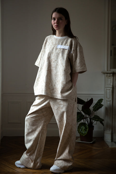 Dalva is wearing White Canvas jacquard natural color, oversized, genderless, seasonless casual t-shirt, one size. The Essential jacquard t-shirt has minimal modern aesthetics design allowing comfort and bringing self-confidence. This unique piece is made locally in Paris to reduce environmental impact and guarantee high quality and durability of the products. 