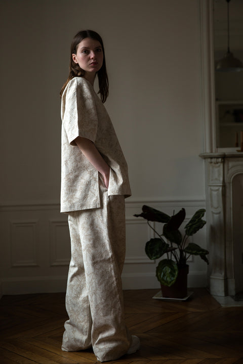 Dalva is wearing White Canvas jacquard natural color, oversized, genderless, seasonless casual t-shirt, one size. The Essential jacquard t-shirt has minimal modern aesthetics design allowing comfort and bringing self-confidence. This unique piece is made locally in Paris to reduce environmental impact and guarantee high quality and durability of the products. 