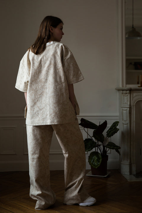 Dalva is wearing White Canvas jacquard natural color, oversized, genderless, seasonless casual t-shirt, one size. The Essential jacquard t-shirt has minimal modern aesthetics design allowing comfort and bringing self-confidence. This unique piece is made locally in Paris to reduce environmental impact and guarantee high quality and durability of the products. 