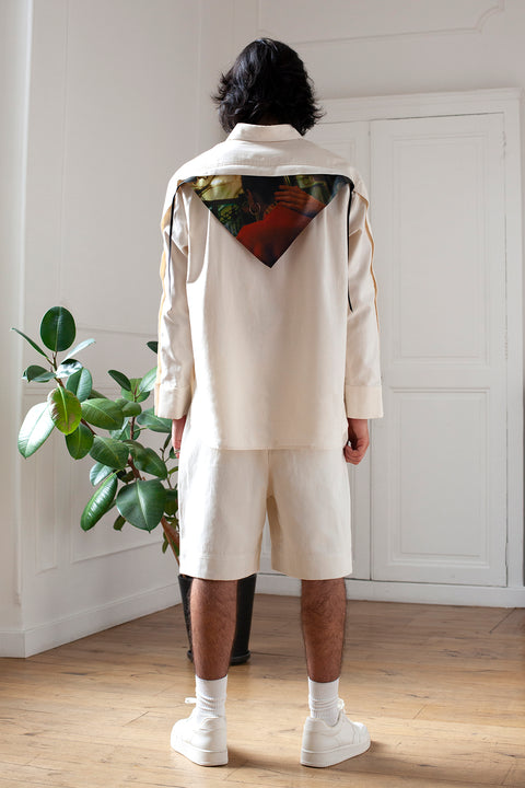 Medhi is wearing the White Canvas essential shirt styled with the Hand triangular panel and bandana made from deadstock cotton poplin. The bandana has an exclusive print of a photo by the photographer Henrique Soares. Attach the panel to the essential pieces to personalize them and wear them your unique way. It is the perfect creative summer accessory.