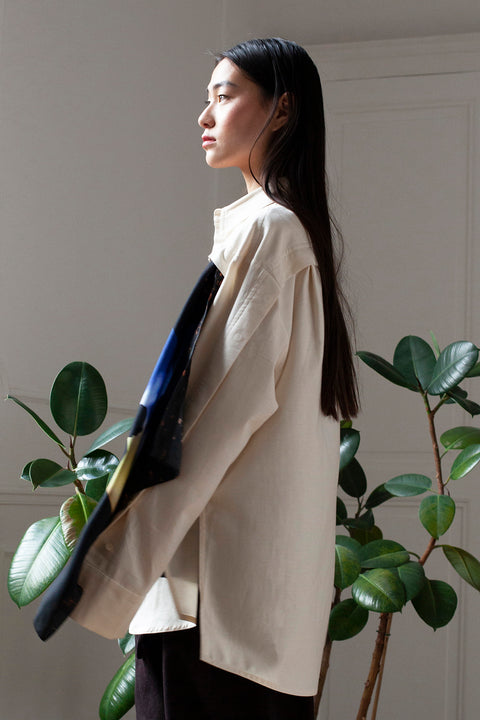 SiJia is wearing the White Canvas ESSENTIAL SHIRT styled with the Shadows foulard and square panel made from a qualitative silk fabric. The foulard is printed in France with an exclusive photo by the photographer Henrique Soares. Wear the foulard alone or attach it to the essential pieces to personalize them and wear them your unique way. Your perfect summer accessory. White Canvas x Henrique Soares creative collaboration.