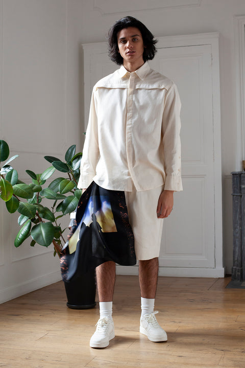 Medhi is wearing the White Canvas denim shorts styled with the Shadows foulard and square panel made from a qualitative silk fabric. The foulard is printed in France with an exclusive photo by the photographer Henrique Soares. Wear the foulard alone or attach it to the essential pieces to personalize them and wear them your unique way. Your perfect summer accessory. White Canvas x Henrique Soares creative collaboration.