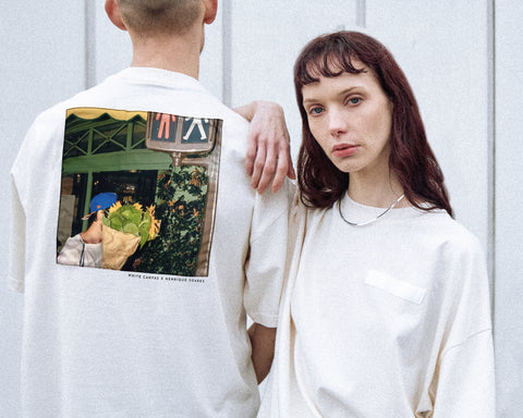 Two models are wearing the White Canvas Originals sustainable, oversized, genderless t-shirt, one size. The organic cotton natural color t-shirt has minimal modern aesthetics design allowing comfort and bringing self-confidence. This limited edition collection is made in Portugal to reduce environmental impact and guarantee high quality and durability of the products. There is a photo by the photographer Henrique Soares at the back of the t-shirt.