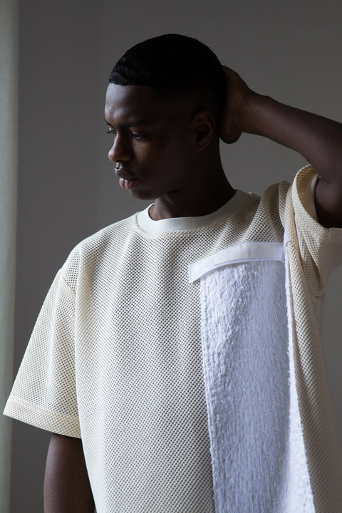 The white tweed panel is an exclusive unique sustainable piece made in France. It is made to be attached to the essential pieces to personalize them and wear them your unique way.