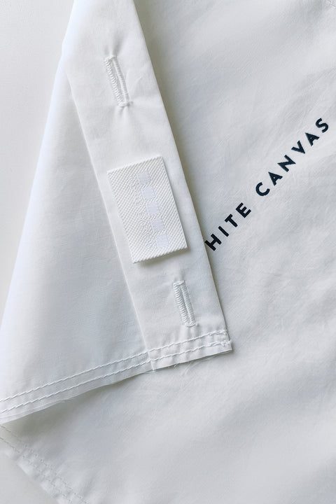 The White Canvas ESSENTIAL SHIRT with white cotton poplin fabric panel made from leftover deadstock fabrics and with black artisanal eco-friendly screen print done locally in Paris in collaboration with RoStudio. Attach the panel to the essential pieces to personalize them and wear them your unique way