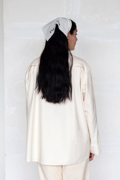 The White Canvas ESSENTIAL SHIRT with white cotton poplin fabric panel made from leftover deadstock fabrics and with black artisanal eco-friendly screen print done locally in Paris in collaboration with RoStudio. Attach the panel to the essential pieces to personalize them and wear them your unique way