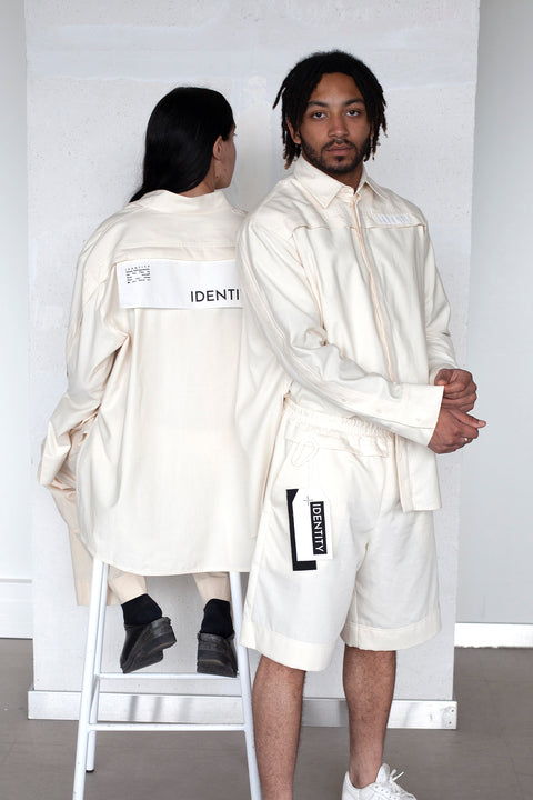 The White Canvas ESSENTIAL SHIRT with white cotton poplin fabric panel made from leftover deadstock fabrics and with black artisanal eco-friendly screen print done locally in Paris in collaboration with RoStudio. Attach the panel to the essential pieces to personalize them and wear them your unique way