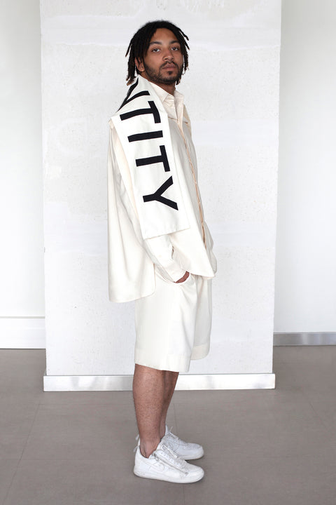 The White Canvas scarf in natural cotton color made from leftover deadstock fabrics and with black patched IDENTITY letters. Unique piece, made in France