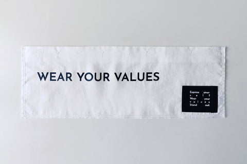 The White Canvas white cotton poplin fabric panel made from leftover deadstock fabrics and with black patch and artisanal eco-friendly screen print done locally in Paris in collaboration with RoStudio. Attach the panel to the essential pieces to personalize them and wear them your unique way