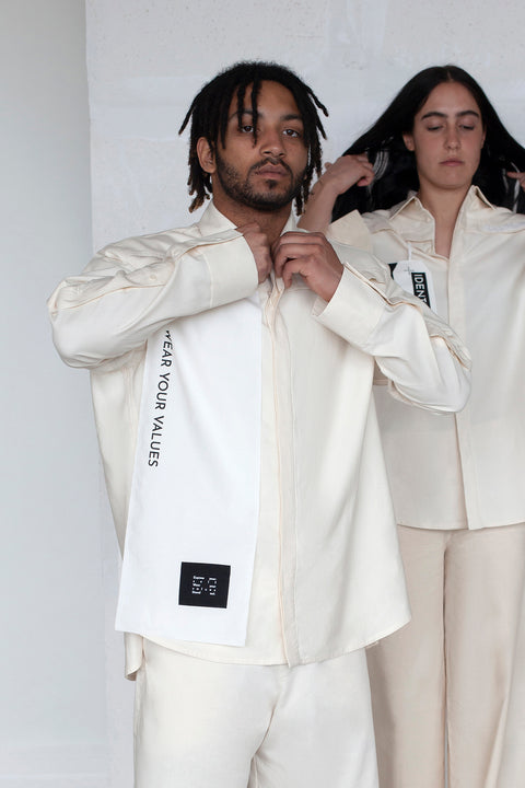 The White Canvas ESSENTIAL SHIRT with white cotton poplin fabric panel made from leftover deadstock fabrics and with black patch and artisanal eco-friendly screen print done locally in Paris in collaboration with RoStudio. Attach the panel to the essential pieces to personalize them and wear them your unique way