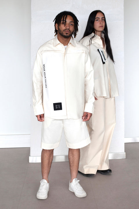 The White Canvas ESSENTIAL SHIRT with white cotton poplin fabric panel made from leftover deadstock fabrics and with black patch and artisanal eco-friendly screen print done locally in Paris in collaboration with RoStudio. Attach the panel to the essential pieces to personalize them and wear them your unique way