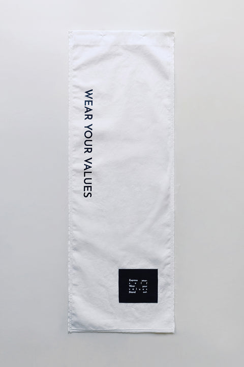 The White Canvas white cotton poplin fabric panel made from leftover deadstock fabrics and with black patch and artisanal eco-friendly screen print done locally in Paris in collaboration with RoStudio. Attach the panel to the essential pieces to personalize them and wear them your unique way