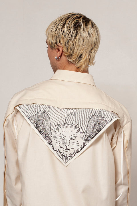 Clément is wearing the White Canvas ESSENTIAL SHIRT styled with THE TWO OF CUPS triangular panel & bandana made from leftover deadstock white cotton poplin. The bandana has an exclusive design inspired by tarot cards drawn by the artist Maria Robla and printed with black artisanal eco-friendly ink locally in Paris in collaboration with RoStudio. Wear the black and white bandana alone or attach it to the essential pieces to personalize them and wear them your unique way. Your perfect summer accessory.
